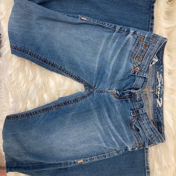 Blue low-rise Seven7 flare jeans with a subtle flare